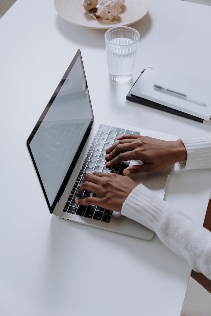 Tangot tantsitakse ikka kahekesi, vol 2 A woman typing on a laptop at a minimalist, modern home office desk, showcasing productivity.